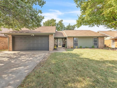 Ranch-style house with a front yard and a garage