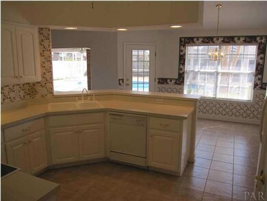 Enjoy a view of the pool from your kitchen sink! Just outside the double window is a BEAUTIFUL River Birch shade tree!