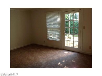 Living Room. Large living room with dental molding opens to private patio