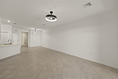 Unfurnished living room featuring a sink, visible