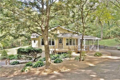Side porch and rear patio. Driveway wraps up and a