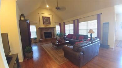 Large open concept living room with vaulted ceilings has plenty of natural light.