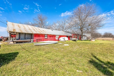 Rear view of property featuring an outbuilding, a