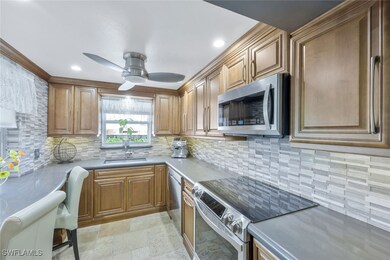 Kitchen with stone finish floor, a sink, backsplas
