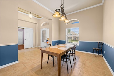Dining area featuring baseboards, ornamental mold
