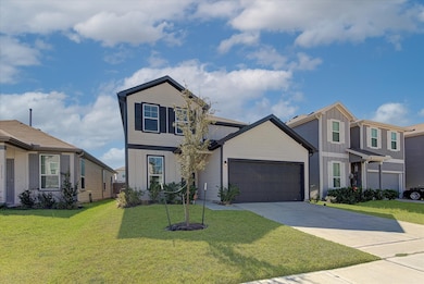 This modern two-story home features a clean exterior design with a dark garage door and shutters. It has a well-maintained front lawn and is situated in a suburban neighborhood with similar style houses.