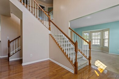 Staircase with hardwood / wood-style floors