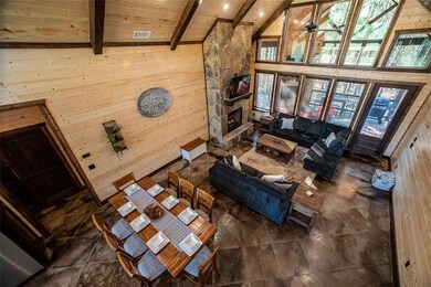 Living room with high vaulted ceiling, wooden wall