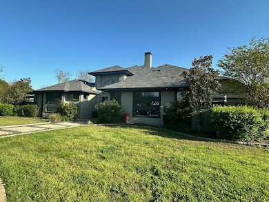 View of front of property with a chimney, a front 