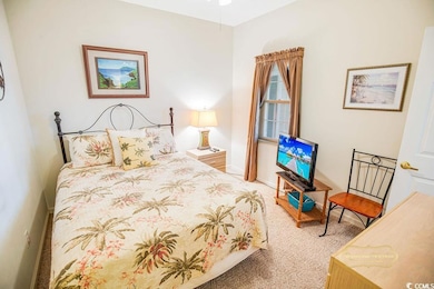 Bedroom featuring carpet floors and baseboards