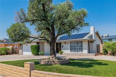 View of front of house with driveway, solar panels