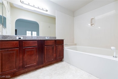 Bathroom featuring a garden tub and double vanity