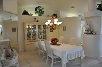Large formal dining room with vaulted ceilings and