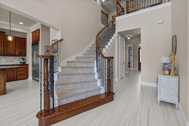 Stairs featuring recessed lighting, a high ceiling