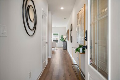 Hall featuring dark wood-style flooring and recessed lighting