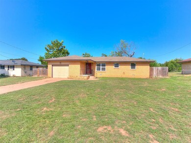 Ranch-style house with a garage and a front yard