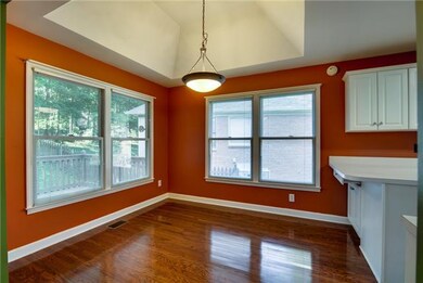 THE BREAKFAST ROOM IS FLANKED BY THE LIVING ROOM AND KITCHEN AND FEATURES GLEAMING HARDWOODS, OVERSIZED WINDOWS, AND A VAULTED CEILING. STOOLS CAN ALSO SIT UP AGAINST THE PENINSULA FOR EXTRA SEATING AND NOTICE THE ADDITIONAL CABINETS UNDERNEATH.