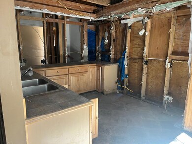 Kitchen with existing cabinets; more cabinets in l