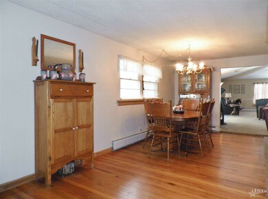 Wood floors grace this dining area, could be exten