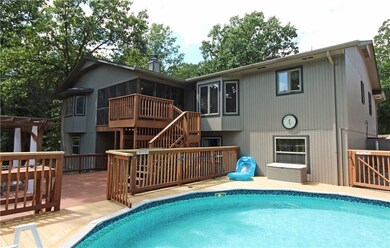Nice pool with 1100 sq. ft. deck with a pergola off lower level family room.