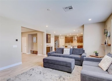 Living room featuring recessed lighting, light woo