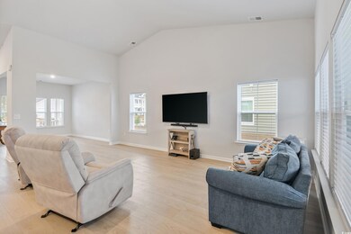Living room with a wealth of natural light, high v