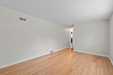 Unfurnished room featuring light wood-type flooring and baseboards