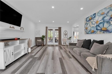 Living room with ornamental molding, light hardwoo