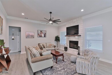Living room with ceiling fan, ornamental molding, 