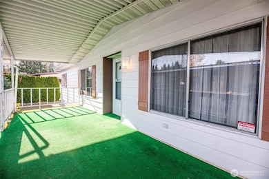 Great front porch perfect for enjoying the weather, but covered from the sun or rain.