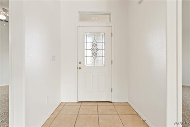 Doorway to outside with light tile patterned floor