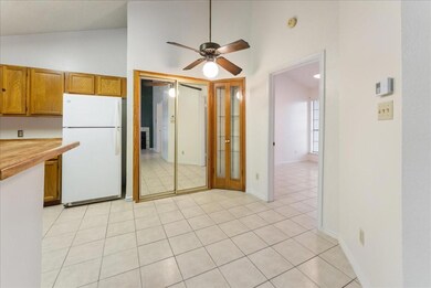 Kitchen featuring ceiling fan, high vaulted ceilin
