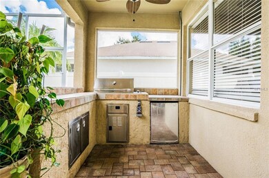Outdoor kitchen with grill, fridge and bar area fo