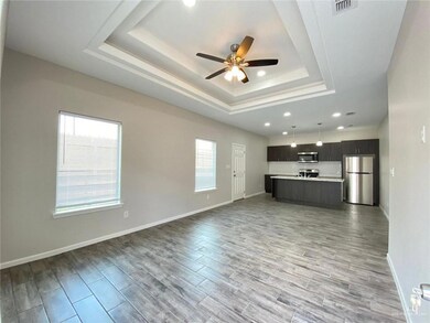 Unfurnished living room featuring visible vents, a raised ceiling, ceiling fan, wood finish floors, and recessed lighting