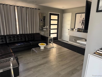 Living room featuring light wood finished floors and baseboards