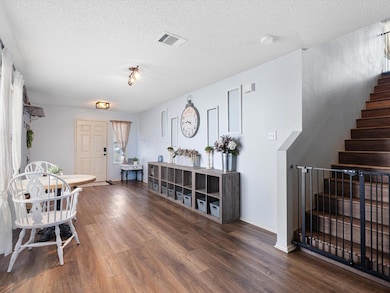 View of front facade featuring a garage, central AC, and a front lawn