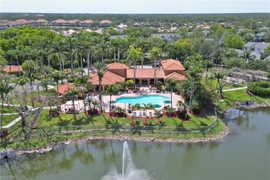 Aerial perspective of suburban area with a pool and a nearby body of water