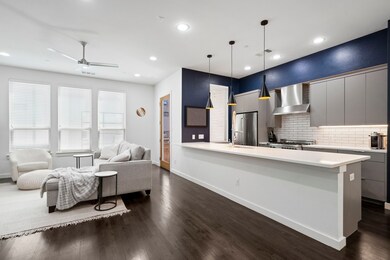 Kitchen featuring dark wood-style flooring, gray cabinets, light countertops, backsplash, and modern cabinets