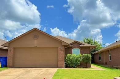 Single story home featuring driveway, an attached garage, a front lawn, brick siding, and roof with shingles