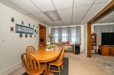 Dining room featuring baseboards, a drop ceiling, 
