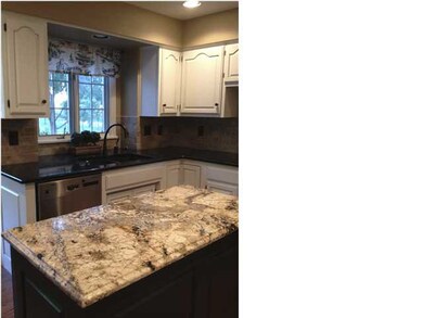 Newly updated kitchen with granite countertop isla
