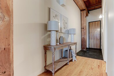 Natural wood floors & beautiful exposed beams.