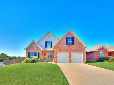 Traditional home with driveway, board and batten siding, brick siding, and a garage