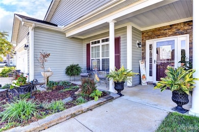 Property entrance featuring a porch and a garage