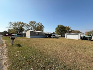 View of yard with an outbuilding and a detached ga