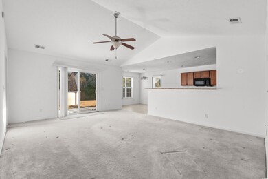 Unfurnished living room featuring ceiling fan with