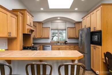 The skylight in the kitchen provides ample natural light.  The breakfast bar has room for 4 stools.