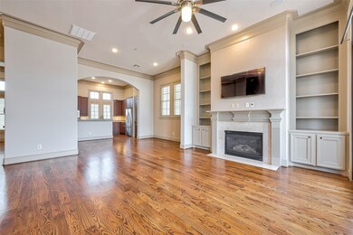 View of gas log fireplace with custom built ins &