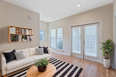 Living room featuring light wood-style floors, re