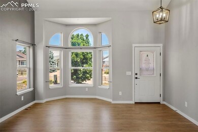 Foyer entrance featuring a chandelier, a towering 